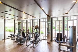 a gym with several treadmills and elliptical machines at Phuket Town 1 Bedroom Condo Luxury Facilities, The Base Downtown in Phuket Town