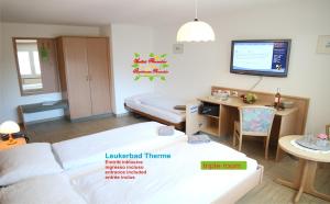 Un pat sau paturi într-o cameră la Hotel Paradis-Leukerbad-Therme