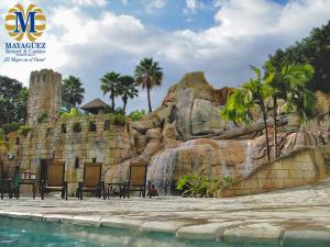a water park with chairs and a waterfall at Mayaguez Resort & Casino in Mayaguez