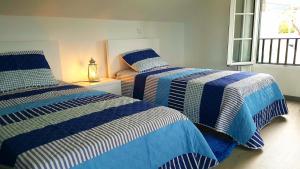 two beds sitting next to each other in a bedroom at La Casa de la Abuela in Ponta do Sol +53 photos