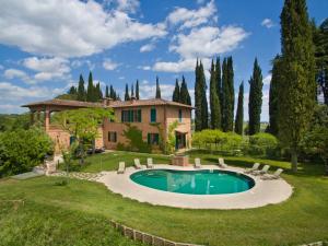 an estate with a swimming pool in front of a house at Villa Larniano in Siena