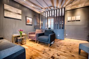 a living room with a couch and a chair at The Grey House in Honfleur