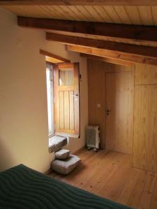 a room with a bed and a window and a door at Casa do Alentejo in Alpalhão