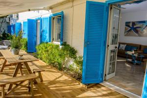a patio with blue shutters on a house at Villa Saline in Palinuro