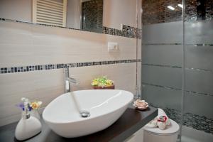 a bathroom with a white tub and a glass shower at Florence Tower Apartment in Florence
