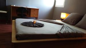 a bedroom with a bed with a blanket at LE Colibri in Le Dix-Septième