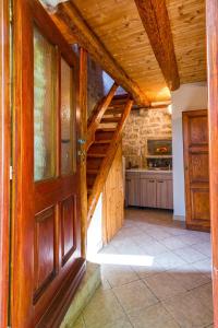 a room with a wooden door and a kitchen at Old Small Stone House in Korčula