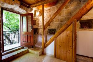 a room with a staircase and a window at Old Small Stone House in Korčula +21 photos