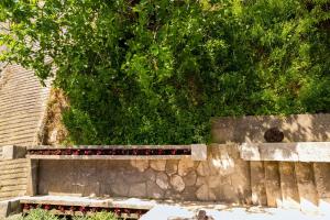 a stone bench sitting on top of a stone wall at Old Small Stone House in Korčula