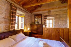a bedroom with a bed in a room with wooden walls at Old Small Stone House in Korčula