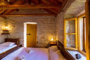a bedroom with two beds and a window at Old Small Stone House in Korčula