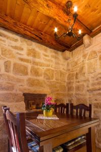 a dining room table with chairs and a stone wall at Old Small Stone House in Korčula