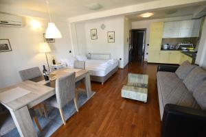 a living room with a table and a couch at Villa Lollobrigida in Ohrid