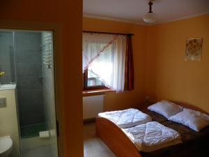 Postel nebo postele na pokoji v ubytování Dom Goscinny Andy