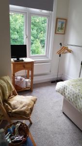 a room with a desk and a bed and a computer at Uppingham in Steyning