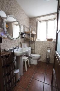a bathroom with a sink and a toilet and a mirror at Casa Rural Calecha in Caboalles de Abajo +48 photos