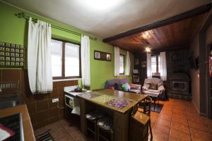 a kitchen with green walls and a table in a room at Casa Rural Calecha in Caboalles de Abajo