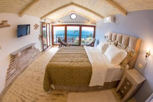 a bedroom with a large bed with a view of the ocean at Medin Apartments BluVista in Petrovac na Moru