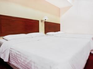 Postel nebo postele na pokoji v ubytování Sun Inns Hotel Subang