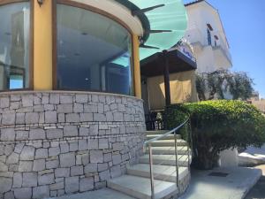 a house with a staircase in front of a building at La Conchiglia in Sperlonga +90 photos