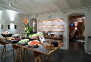 a table with bowls of food on it in a room at Home Hotel Jugend in Helsinki