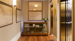 a hallway with a glass display case in a room at Porto A.S. 1829 Hotel in Porto