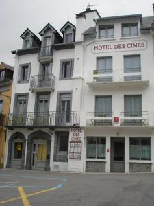 a hotel des chimes building on the corner of a street at Hôtel des Cimes in Luz-Saint-Sauveur