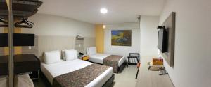 En eller flere senger på et rom på Hotel Genova Prado