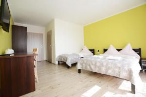 Кровать или кровати в номере Neptun