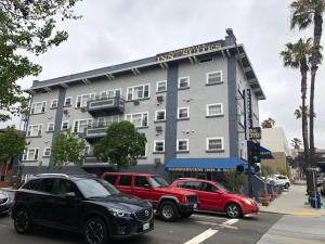 a large building with cars parked in front of it at Harborview Inn & Suites-Convention Center-Airport-Gaslamp-Seaworld-Zoo-Balboa Park in San Diego