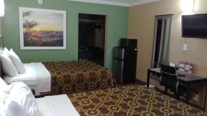 A television and/or entertainment centre at Days Inn by Wyndham Houston East