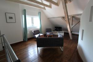 a living room with two chairs and a couch at Entre douceur et délicatesse in Colmar