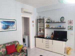 a living room with a tv and a couch at Guest House Adele in Marina di Ragusa