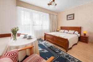 a hotel room with a bed and a table at Willa Daria in Władysławowo