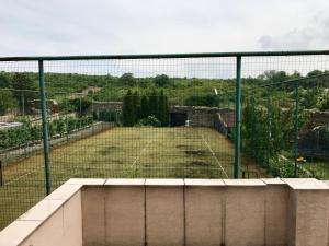 a tennis court behind a fence with a tennis court at Club M.K.M. Modra in Modra