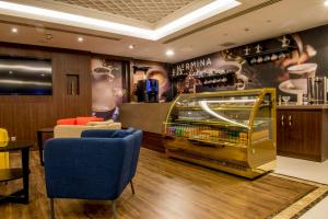 a bar with a ping pong table in a room at نورمينا للشقق المخدومة in Dammam
