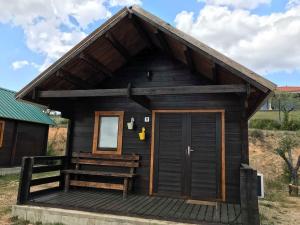 a small cabin with a porch and a door at Monte do Azibo Glamping in Podence