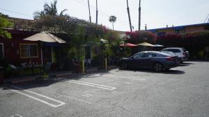 a car parked in a parking lot next to a building at Villa Brasil Motel in Los Angeles