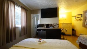 a hotel room with a bed and a kitchen at Villa Brasil Motel in Los Angeles
