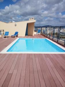 a swimming pool on the roof of a building at Fun & Sun Apartment in Olhão