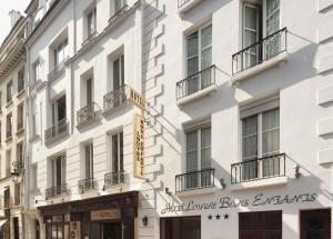 a white building with a sign on the side of it at Hotel Louvre Bons Enfants in Paris