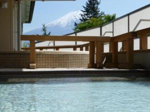a view of a mountain from a house with a swimming pool at Lakeland Hotel Mizunosato in Fujikawaguchiko