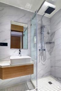 a bathroom with a sink and a shower at Bridal Tea House Hotel-Free Welcome Drink in Guangzhou