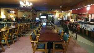 a row of tables and chairs in a restaurant at HWY6HOTEL in Oak Point