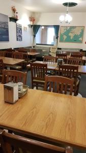 an empty classroom with wooden tables and chairs at HWY6HOTEL in Oak Point