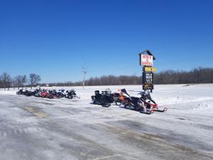 a row of motorcycles parked on the side of a road at HWY6HOTEL in Oak Point