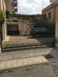 un cancello nero con una macchina parcheggiata dietro di Seaside Idyll a Viareggio