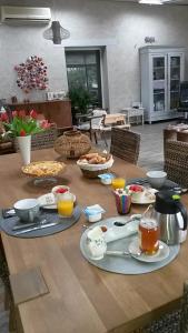 a wooden table with food and drinks on it at Les Gîtes Les Mayombes in Roquebrune-sur-Argens