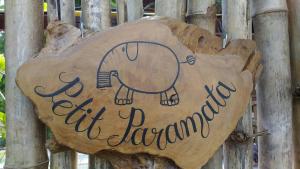 a sign on a fence with an elephant dancing at Petit Paramata in Phitsanulok