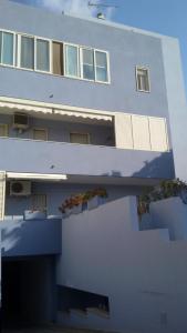 a large white building with windows and a fence at Casa in SALENTO a Otranto in Otranto